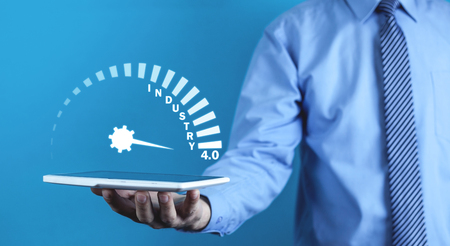 Man holding tablet with Industry 4.0 speedometer.の写真素材