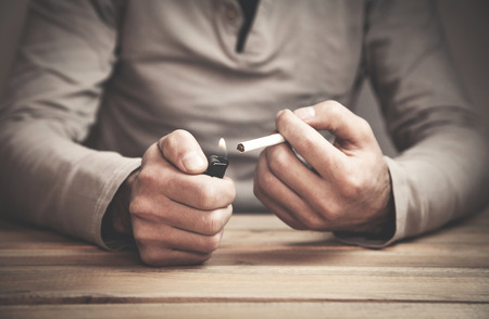 Man lighting cigarette. Cigarette addictionの写真素材