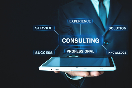 Man holding tablet with Consulting text. Business conceptの写真素材