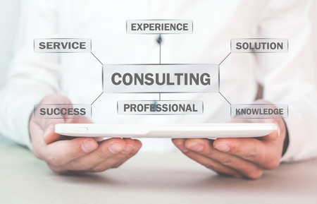 Man holding tablet with Consulting text. Business conceptの写真素材