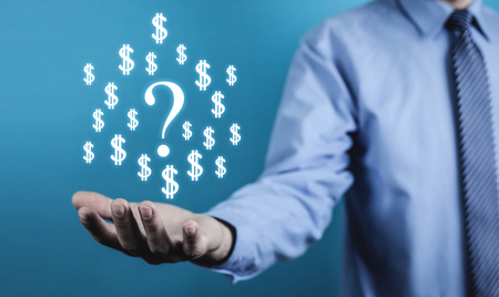 Man holding question mark and dollar symbols. Business conceptの写真素材