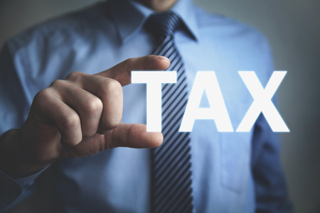 Businessman showing Tax word. Business conceptの写真素材