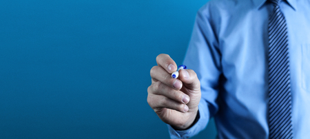 Caucasian businessman pointing a pen on a virtual screen.の写真素材