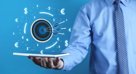 Man holding target with currency symbols. Concept of successの写真素材