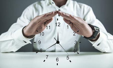 Businessman protect clock. Concept of saving timeの写真素材