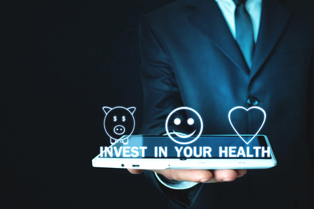 Man holding tablet. Invest In Your Healthの写真素材