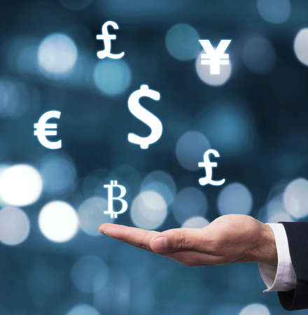 Hand holding currency symbols. Business conceptの写真素材