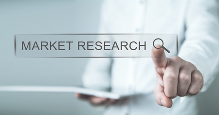Man touching on Market Research search button. Web search conceptの写真素材