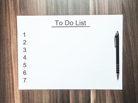 To do list on paper on wood background with space.