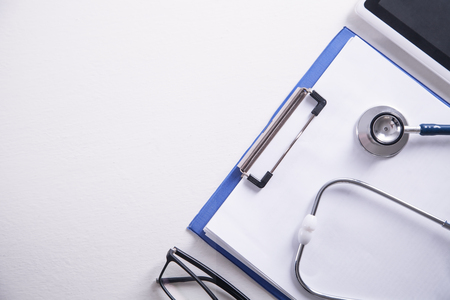 Stethoscope, medicine clipboard, tablet and glasses. Doctor workplaceの写真素材
