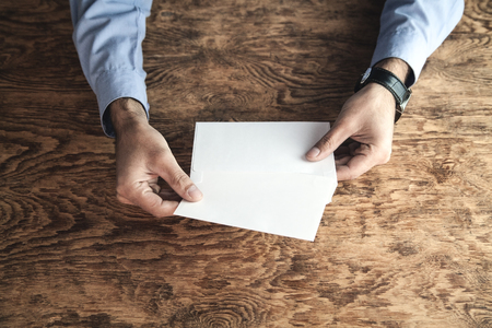 Man holding mail envelope. Business conceptの写真素材