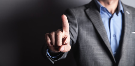 Businessman pointing and touching on a empty touch screen.の写真素材