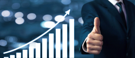 Businessman showing thumbs up sign. Growth graph. Success conceptの写真素材