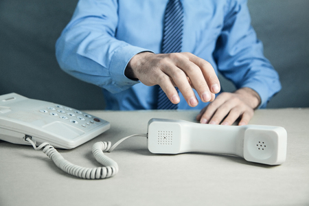 Businessman with office telephone. Contactの写真素材
