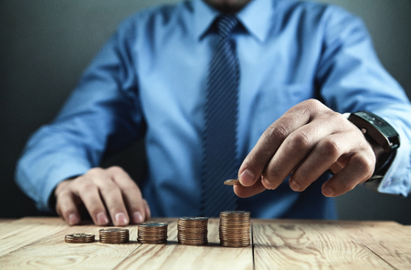 Businessman stacking coins. Budget and finance conceptの写真素材