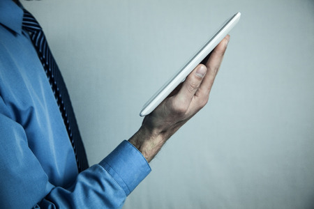 Man holding white digital tablet. Concept of new technology
