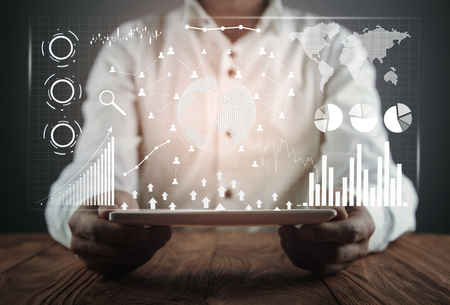 Man holding digital tablet. Financial statistics, business graphs, social network and connection. Future and finance conceptの写真素材