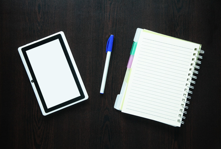 Tablet with notepad on dark background.の写真素材
