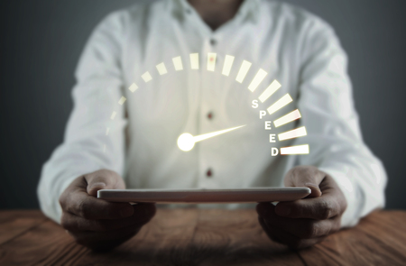 Man holding tablet with speedometer. Speed conceptの写真素材