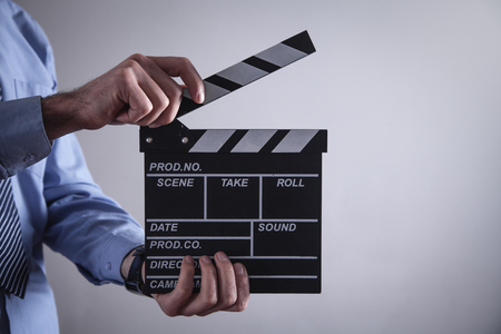 Man holding movie clapper. Making movieの写真素材