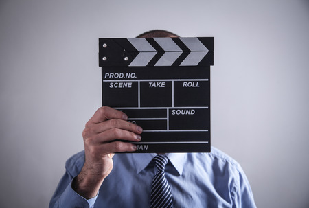 Man holding movie clapper. Making movieの写真素材