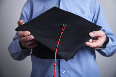 Man holding graduation hat. Educationの写真素材