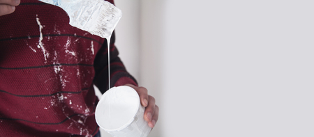 Man hands paintbrush with white paint. Renovationの写真素材