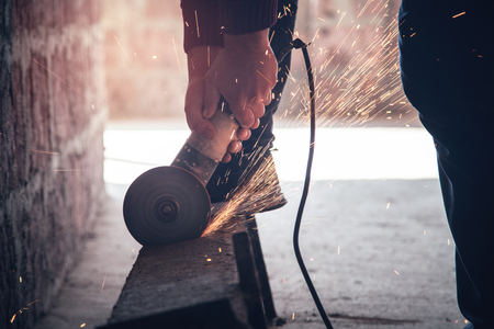 Man cuts metal with a grinder. Industrial conceptの写真素材