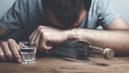 Caucasian alcoholic man with vodka.の写真素材