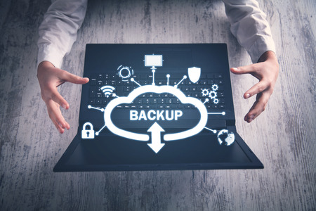Hands protect gesture with laptop. Data Backup. Cloud Download. Internet, Technologyの写真素材