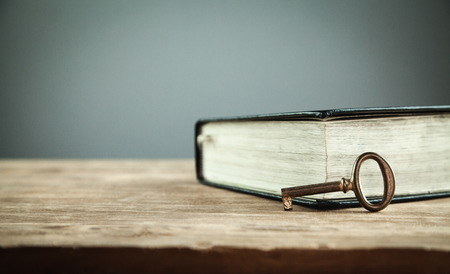 Old key with bible. Concept of wisdom and knowledgeの写真素材