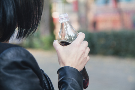 Woman drinking juice in outdoor.