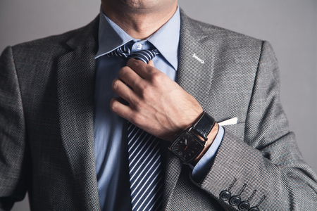 Business Man fixing his tie.の写真素材