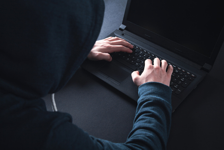 Hacker with laptop. Computer crimeの写真素材