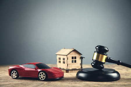 Wooden judge gavel with house and car. Auction and bidding conceptの写真素材