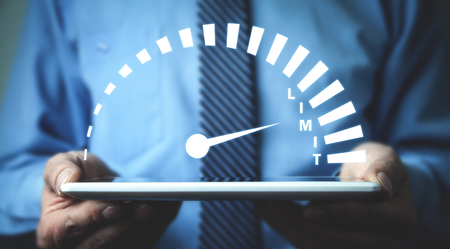 Man holding speedometer with Limit word.の写真素材