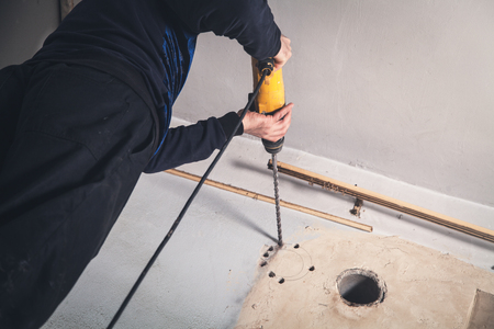 Worker drills a wall with a perforator.の写真素材