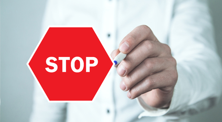 Man hand with a red stop sign.の写真素材