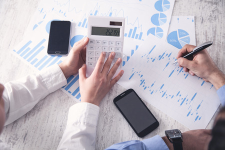 Business people working in office and using calculator.の写真素材