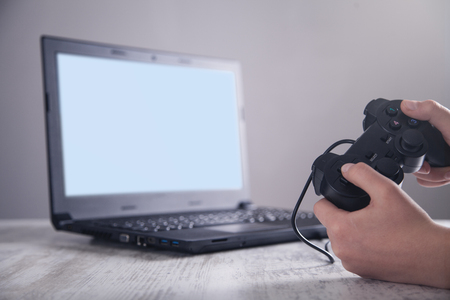 Hands using game controller. Playing video games 