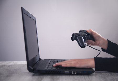Hands using game controller. Playing video gamesの写真素材