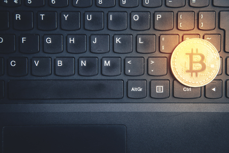 Bitcoin on laptop keyboard. Technology, Commercial and Finance conceptの写真素材