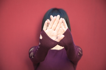 Caucasian woman with hand covering his face.の写真素材