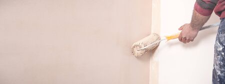Professional painter with roller. Renovationの写真素材