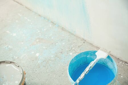 Paintbrush with blue paint. Renovationの写真素材