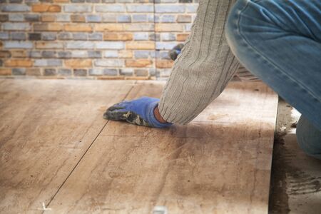 Laying floor ceramic tile. Renovating the floorの写真素材