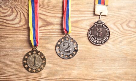 Medal awards for winner on wood background.の写真素材