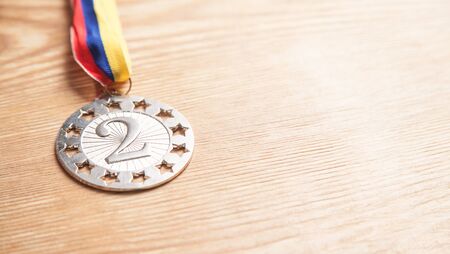 Silver medal on wooden background.の写真素材