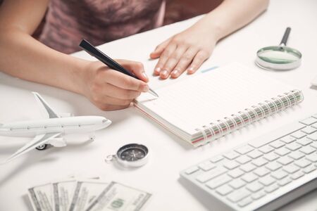 Girl writing on notepad. Concept of travelの写真素材