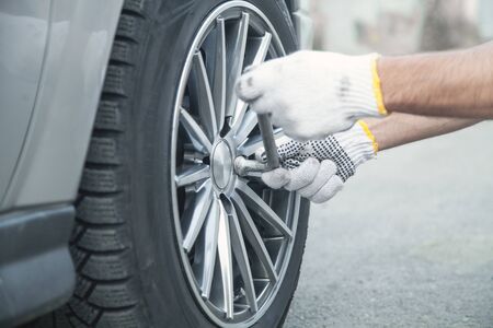 Changing car tire. Car service. Tire installation conceptの写真素材